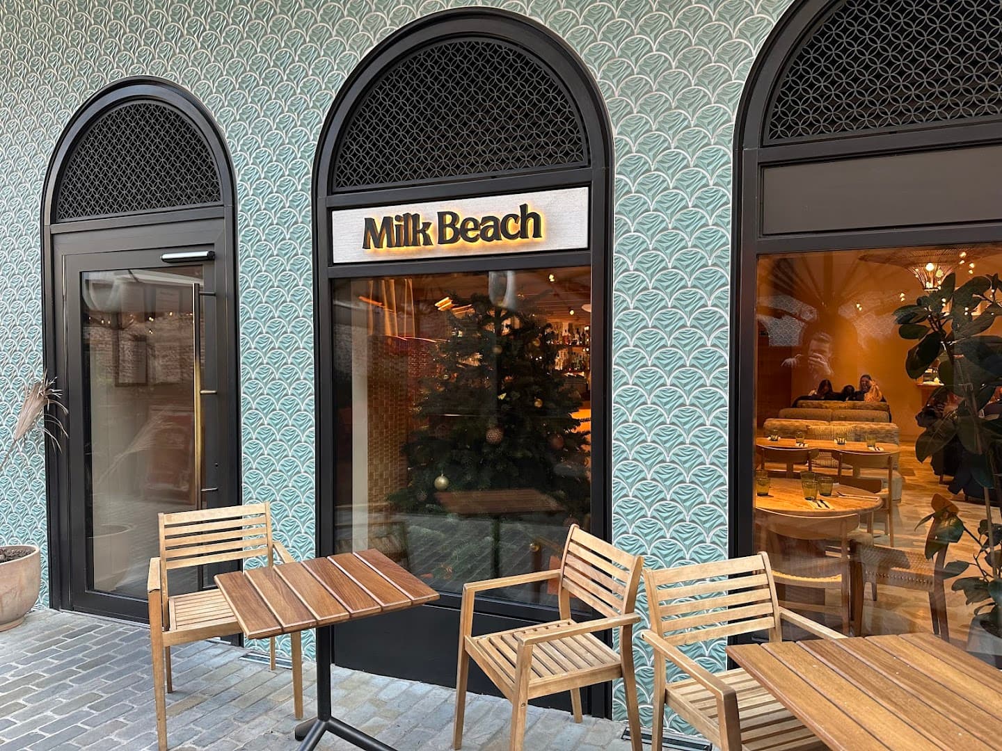 Front entrance with outdoor seating at Milk Beach Soho, London