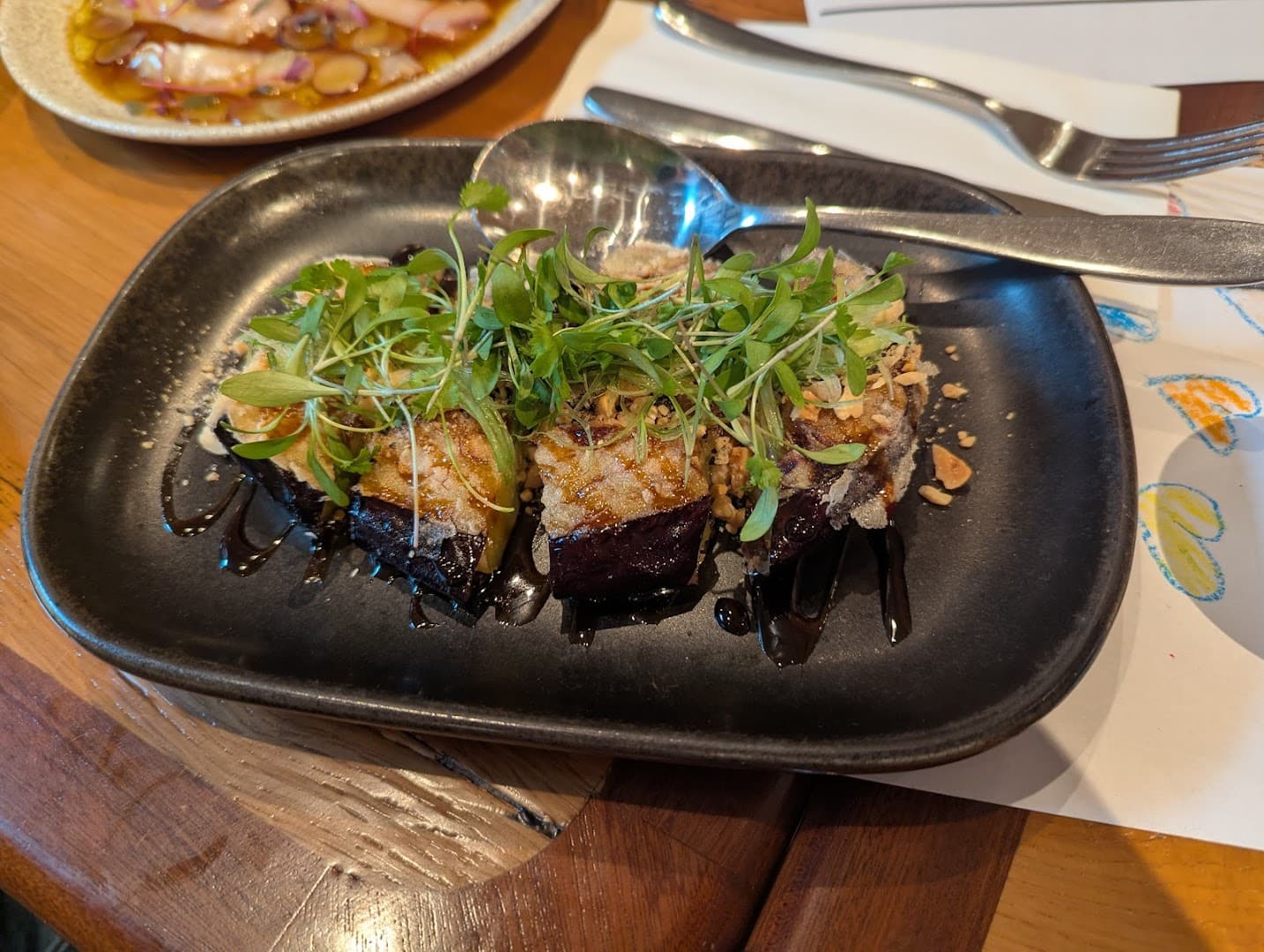 Grilled beef dish with microgreens at Milk Beach Soho, London