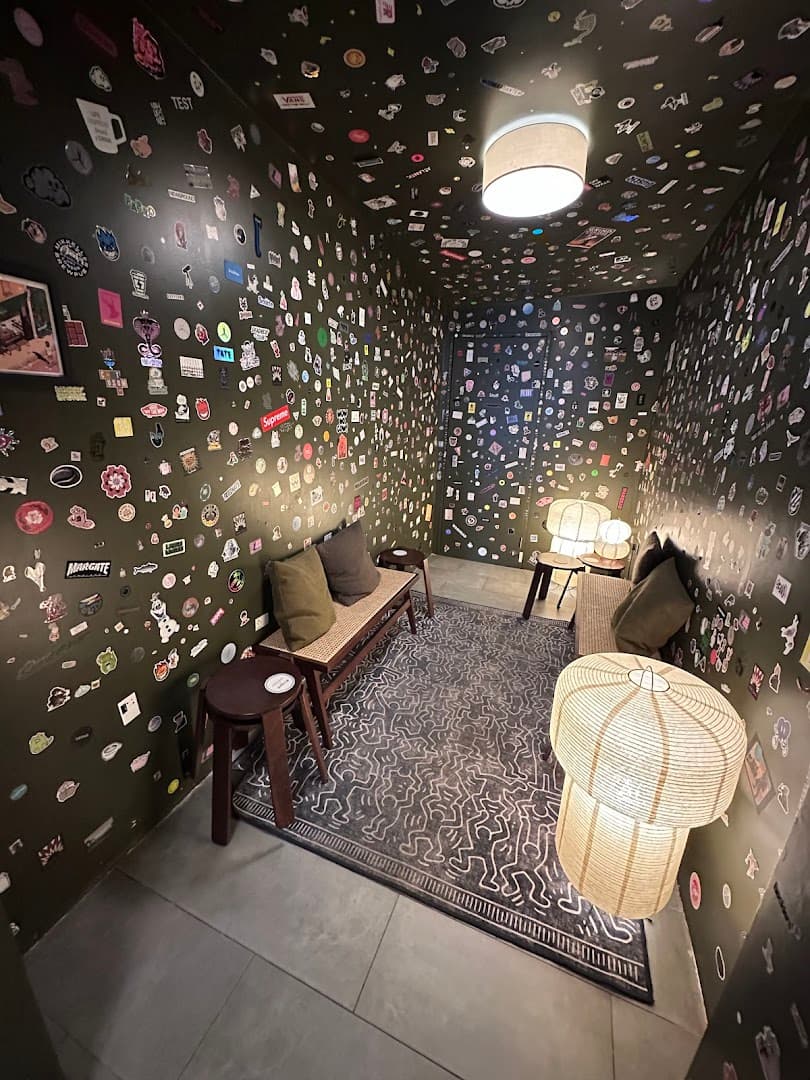 Sticker-wall seating area at Moonstruck Cafe, London