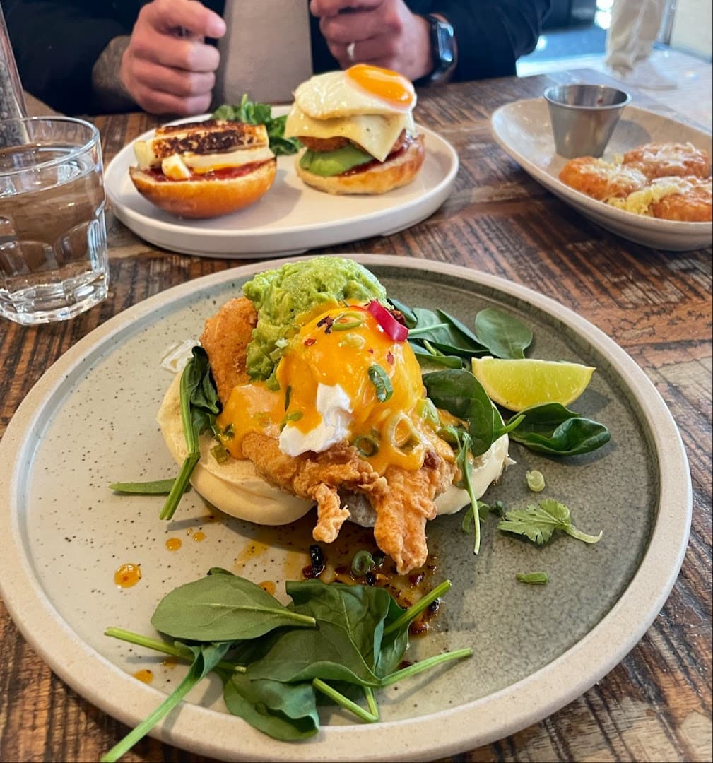 Brunch dishes with poached eggs at Ollie's House Restaurant, Chelsea, London