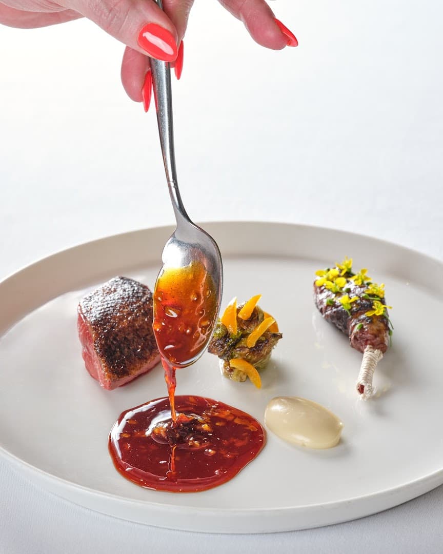 Fine dining meat course with sauce being poured at Pied a Terre, London