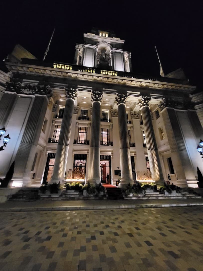 Illuminated neoclassical front facade at Rotunda Bar & Lounge, London