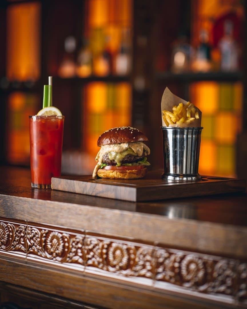 Burger and chips with cocktail at The Cadogan Arms, London