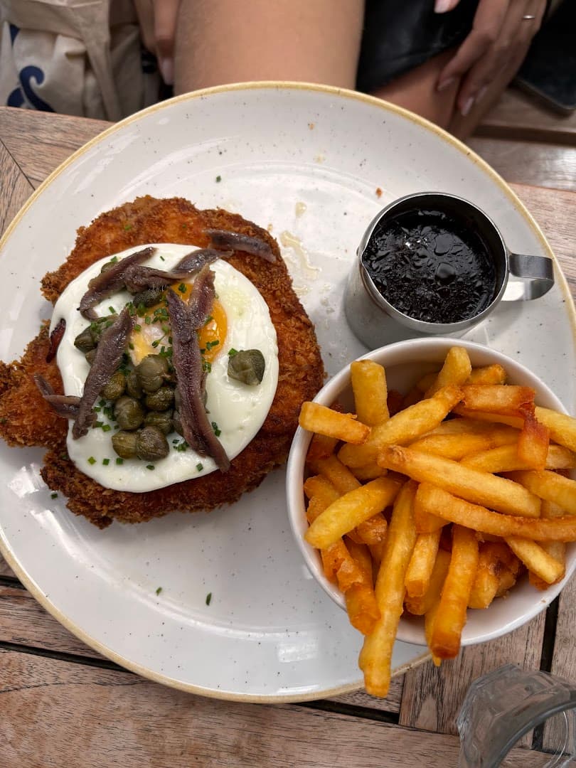Schnitzel with fried egg, capers, and fries at The Duke of Hamilton, London