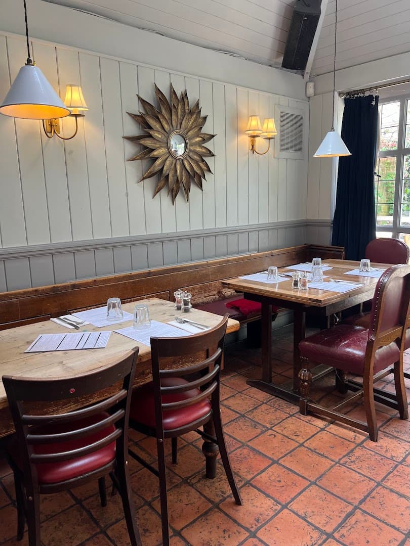 Dining area with banquette seating at The Red Lion & Sun, London
