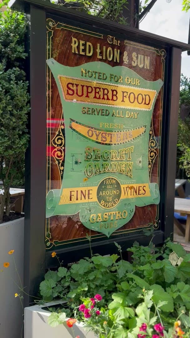 Outdoor signage and garden at The Red Lion & Sun, London