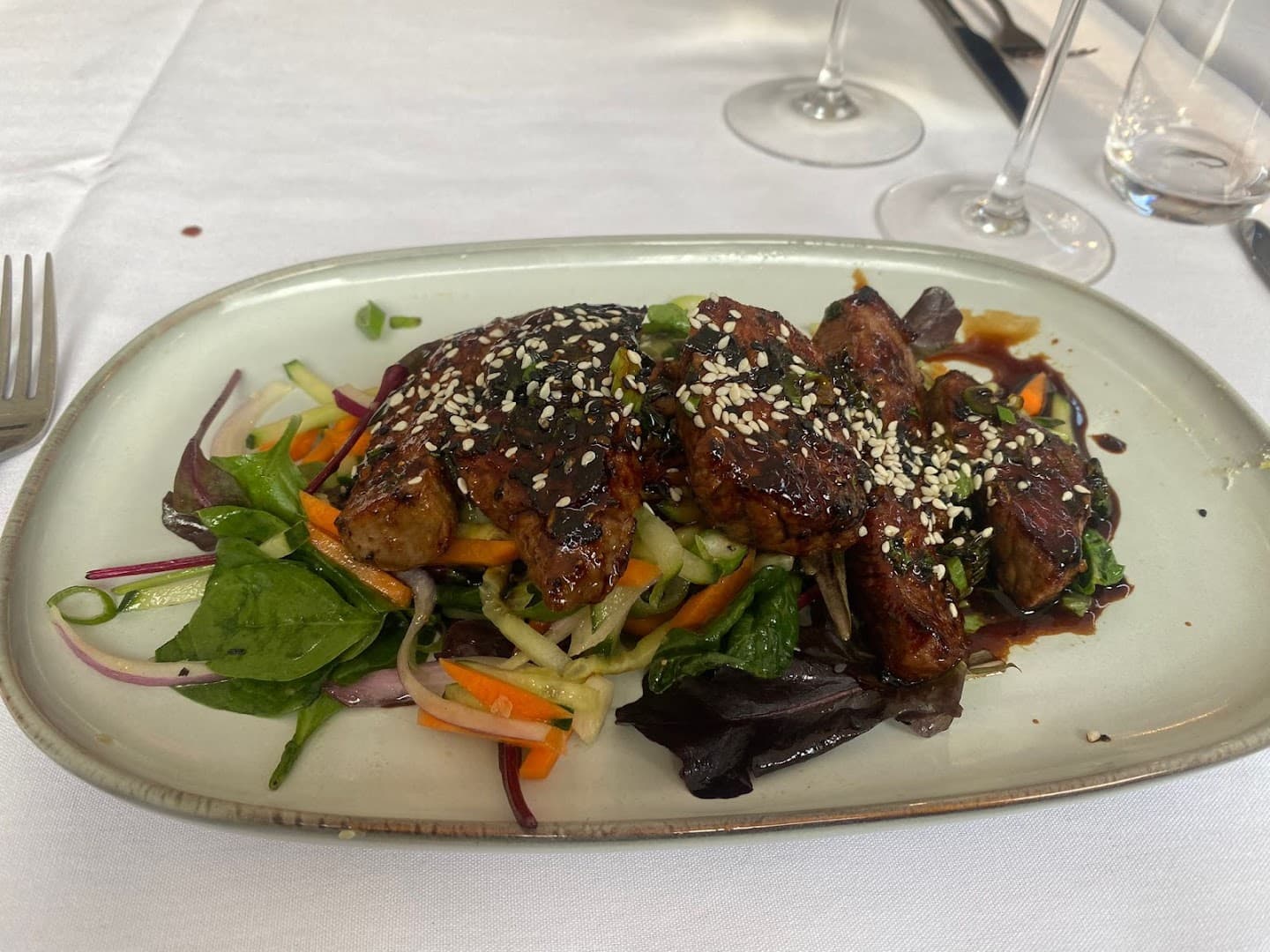 Glazed meat with sesame seeds and salad at The Rising Sun, London
