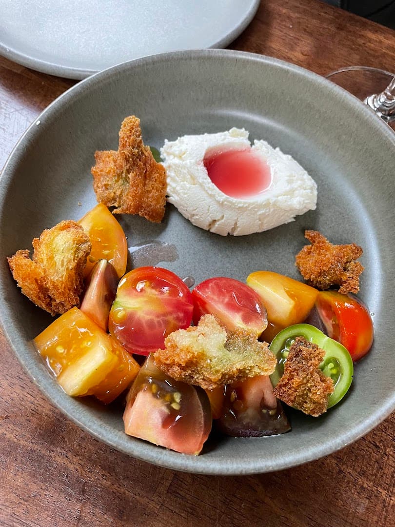 Burrata with heirloom tomatoes and crispy toast at Vins, London