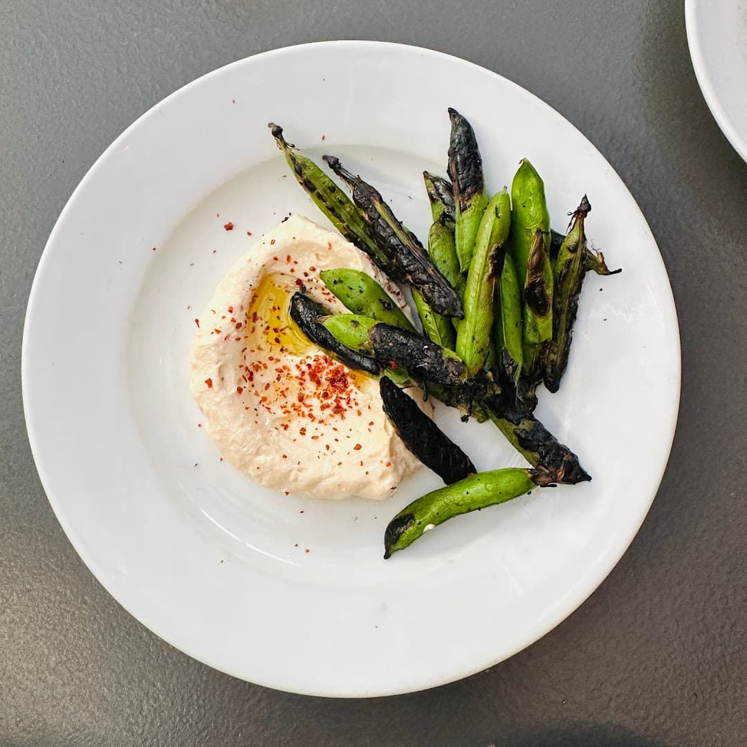Charred snap peas with whipped ricotta at Westerns Laundry, London