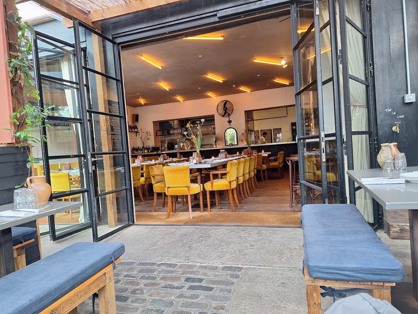 Indoor-outdoor dining area at Westerns Laundry, London